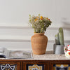 Woven rattan vase styled on table